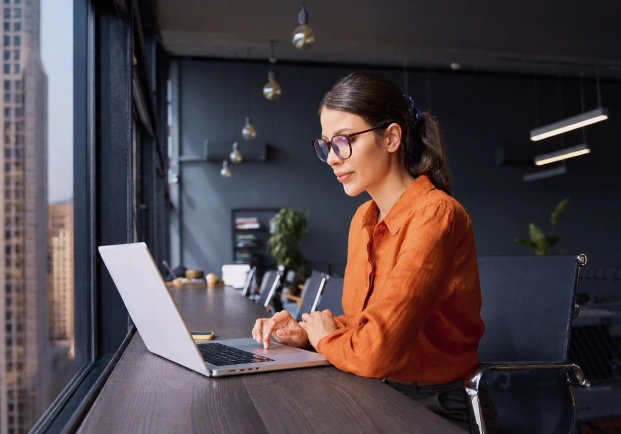 A woman looking at a laptop